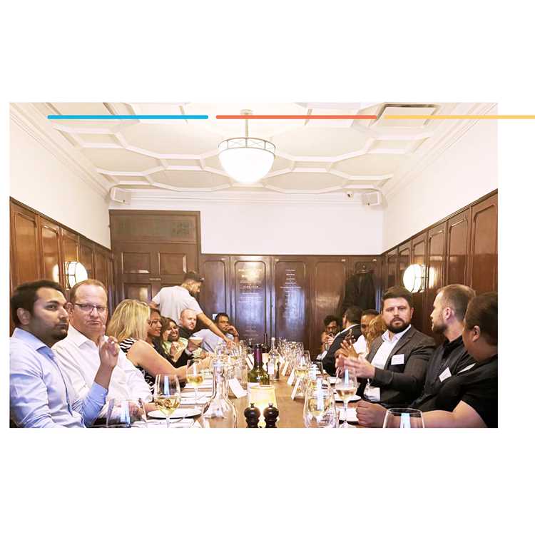 Guests seated along a long dining table in a wood-panelled room at a legal sector dinner event