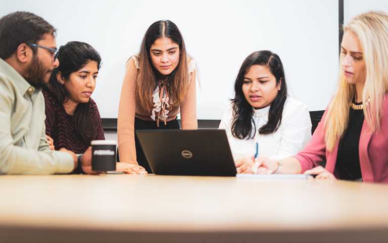 Software Testing Consultants reviewing bar charts and graphs